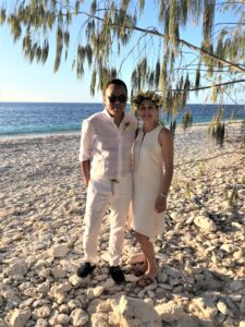 Couple on beach at vow renewal ceremony